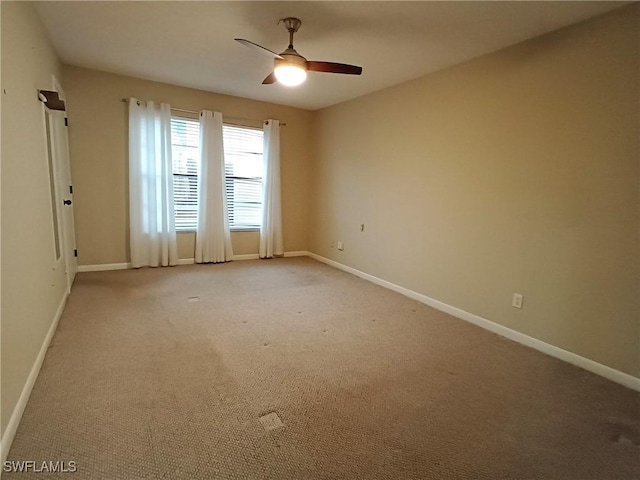 spare room featuring ceiling fan and carpet floors