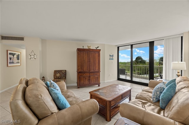 tiled living room featuring floor to ceiling windows