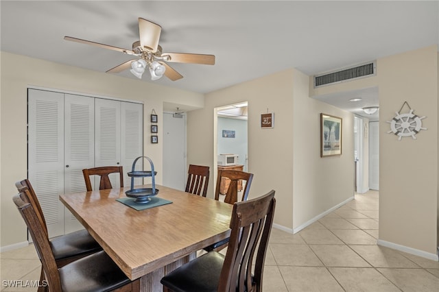 dining room featuring ceiling fan and light tile patterned flooring