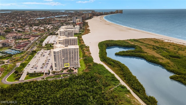 drone / aerial view with a beach view and a water view