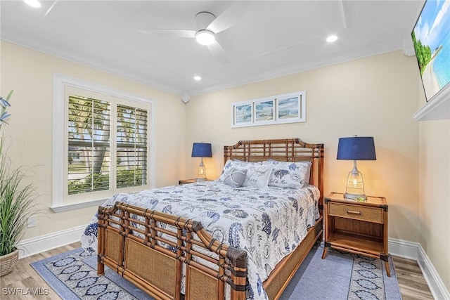 bedroom featuring ceiling fan, crown molding, and wood-type flooring