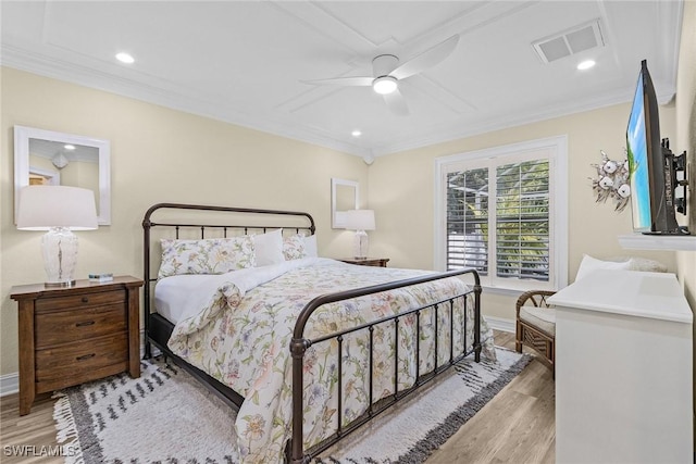 bedroom featuring light hardwood / wood-style flooring, ceiling fan, and ornamental molding