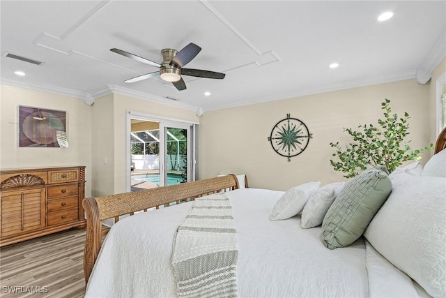 bedroom featuring hardwood / wood-style floors, ceiling fan, and ornamental molding