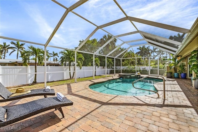 view of swimming pool featuring a lanai, an in ground hot tub, and a patio