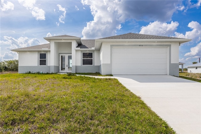 prairie-style house with a garage, a front lawn, concrete driveway, and stucco siding