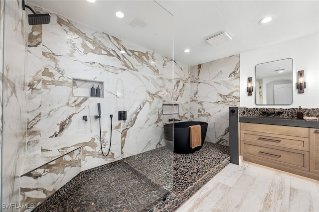 bathroom featuring vanity, a shower, and tile walls