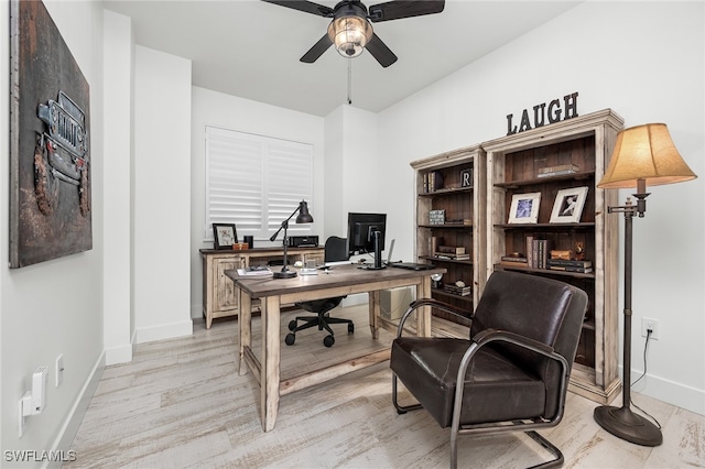 home office with ceiling fan and light hardwood / wood-style flooring