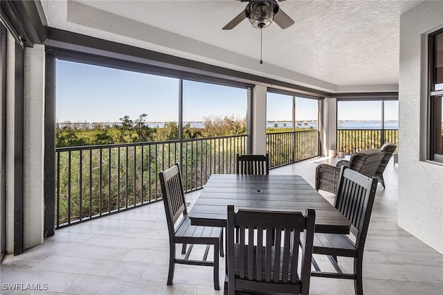 sunroom featuring ceiling fan