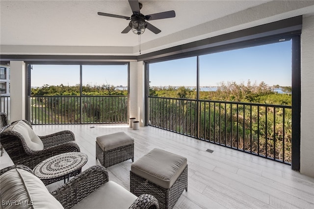 sunroom / solarium featuring ceiling fan