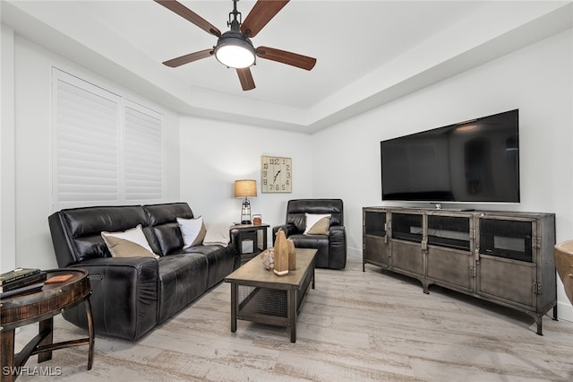 living room featuring ceiling fan and light hardwood / wood-style floors