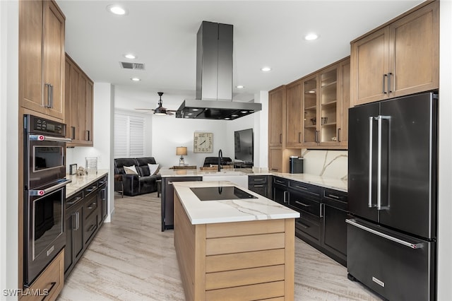 kitchen with ceiling fan, light wood-type flooring, appliances with stainless steel finishes, a kitchen island, and island exhaust hood