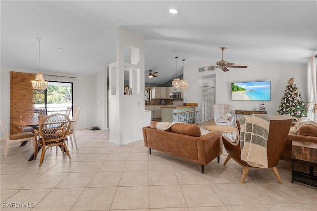 living area featuring light tile patterned floors, visible vents, vaulted ceiling, baseboards, and ceiling fan with notable chandelier