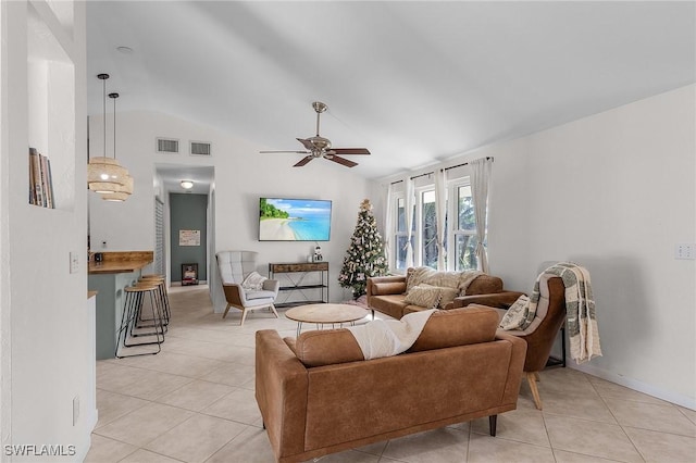 living area featuring lofted ceiling, light tile patterned floors, ceiling fan, and visible vents