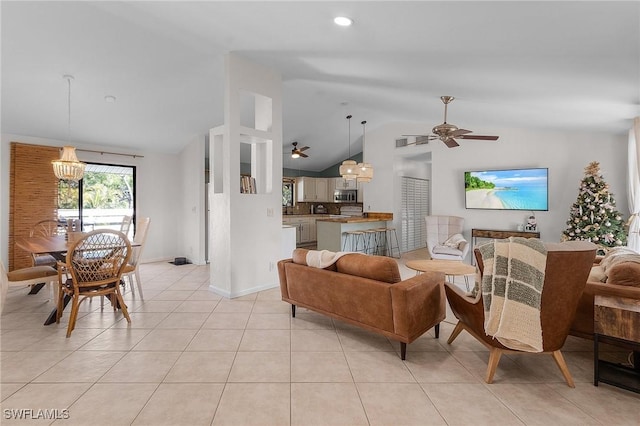 living room with lofted ceiling, baseboards, ceiling fan with notable chandelier, and light tile patterned flooring