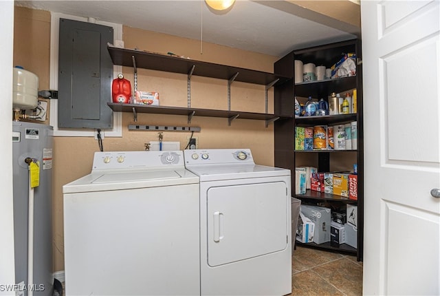 laundry room featuring electric panel, water heater, dark tile patterned flooring, and independent washer and dryer