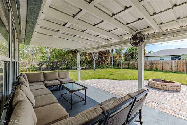 view of patio with an outdoor living space with a fire pit and ceiling fan