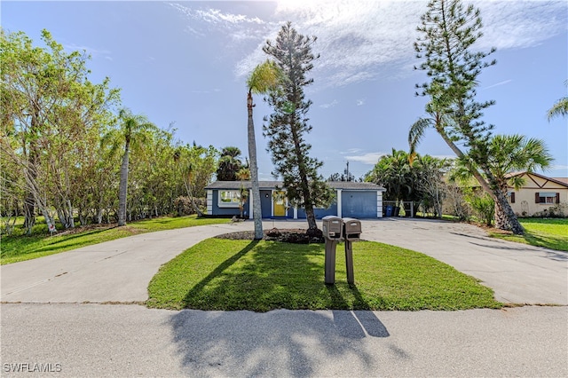 ranch-style home with a front yard and a garage