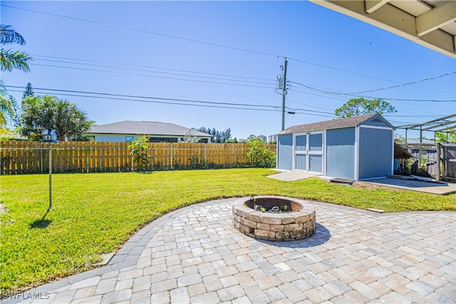 view of patio / terrace featuring a fire pit and a storage shed