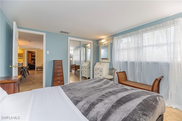 bedroom featuring a closet and light tile patterned flooring