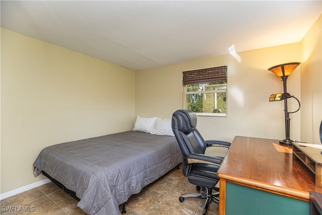 bedroom featuring dark tile patterned flooring