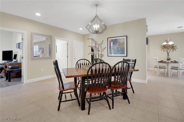 dining space featuring a chandelier and light tile patterned floors