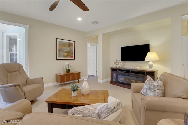 carpeted living room featuring ceiling fan