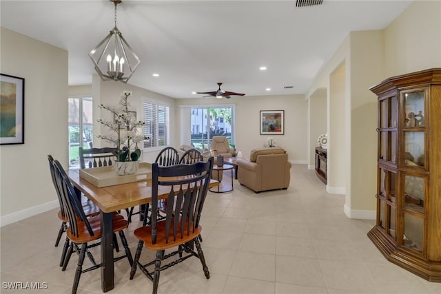 dining space featuring ceiling fan with notable chandelier and light tile patterned floors