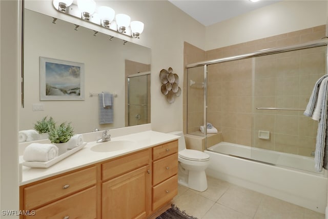 full bathroom with tile patterned flooring, vanity, toilet, and bath / shower combo with glass door