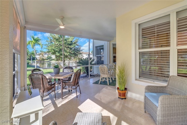 view of patio featuring ceiling fan and a water view