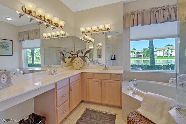 bathroom featuring tile patterned flooring, vanity, and a relaxing tiled tub