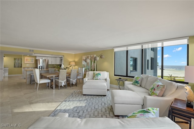 living room featuring a water view and ornamental molding