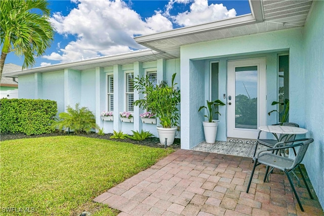 property entrance with a yard