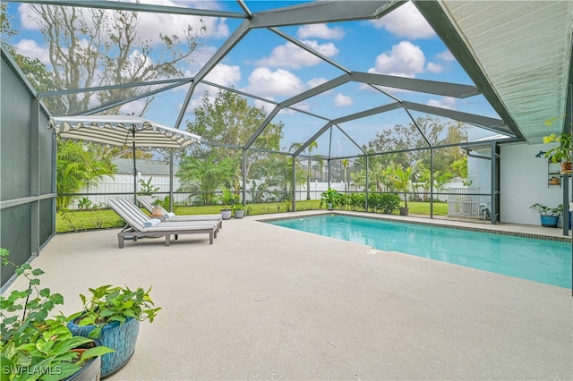 view of swimming pool featuring a patio and a lanai