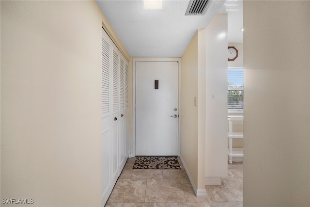 entryway with light tile patterned flooring