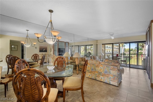 dining area with ceiling fan with notable chandelier and light tile patterned floors