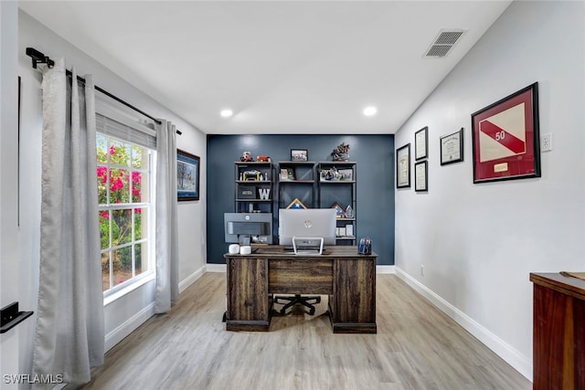 home office with hardwood / wood-style flooring and plenty of natural light