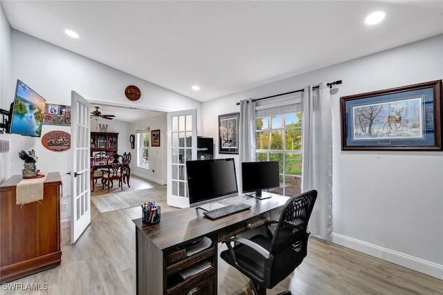 office area with ceiling fan, french doors, light hardwood / wood-style flooring, and vaulted ceiling