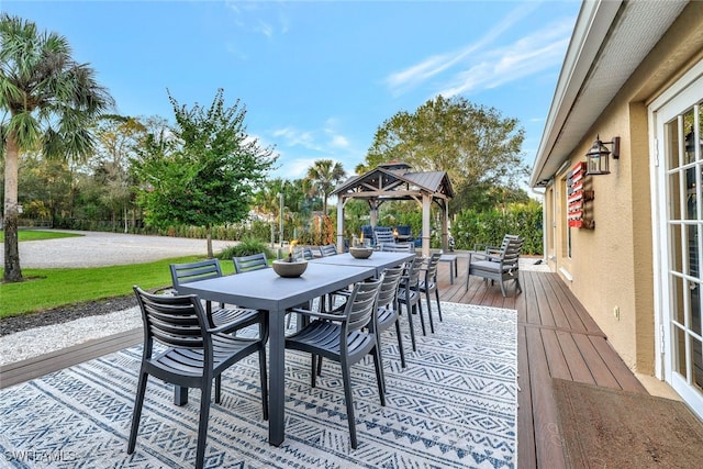 wooden terrace featuring a gazebo