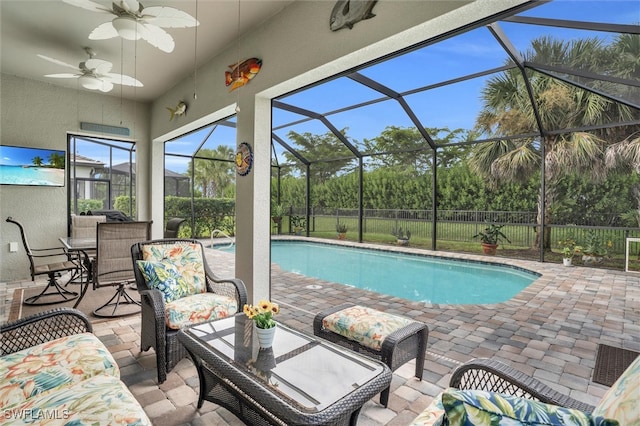 view of swimming pool featuring a lanai, ceiling fan, and a patio