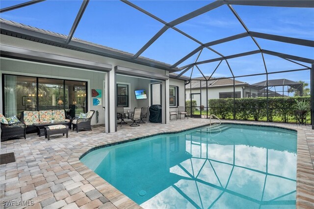 view of swimming pool featuring glass enclosure and a patio