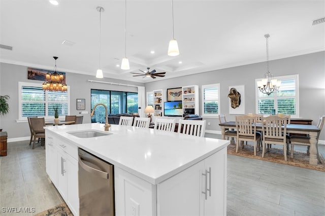 kitchen featuring dishwasher, a kitchen island with sink, a healthy amount of sunlight, and sink