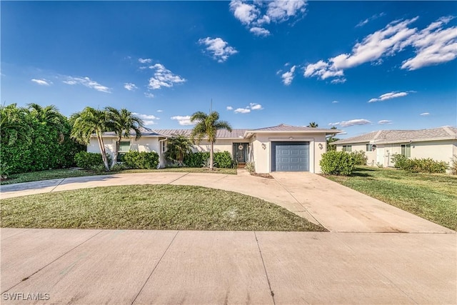 view of front of home with a garage and a front lawn