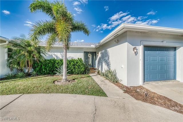 doorway to property with a garage