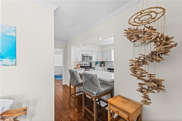 dining space featuring wood-type flooring and ornamental molding