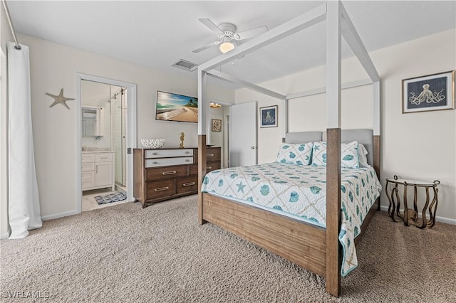 bedroom featuring ensuite bathroom, ceiling fan, and light colored carpet