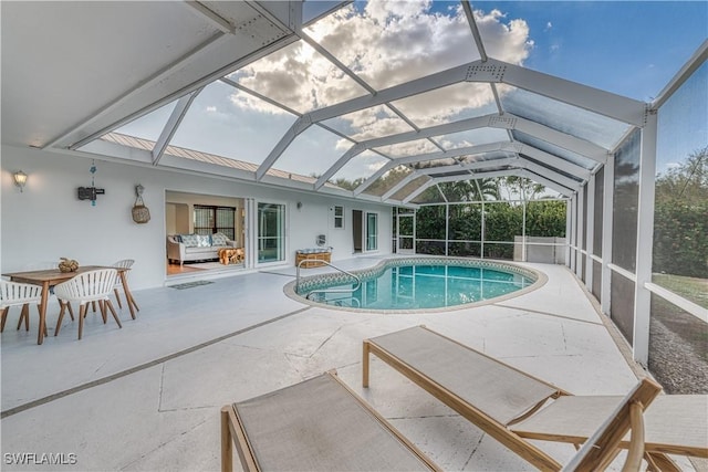 view of swimming pool with glass enclosure and a patio area