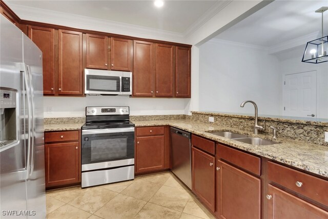 kitchen featuring appliances with stainless steel finishes, light stone counters, ornamental molding, sink, and hanging light fixtures