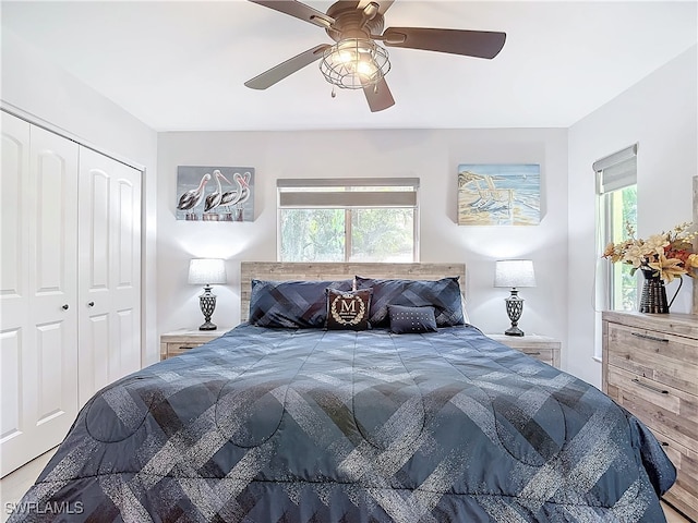 bedroom with ceiling fan, multiple windows, and a closet