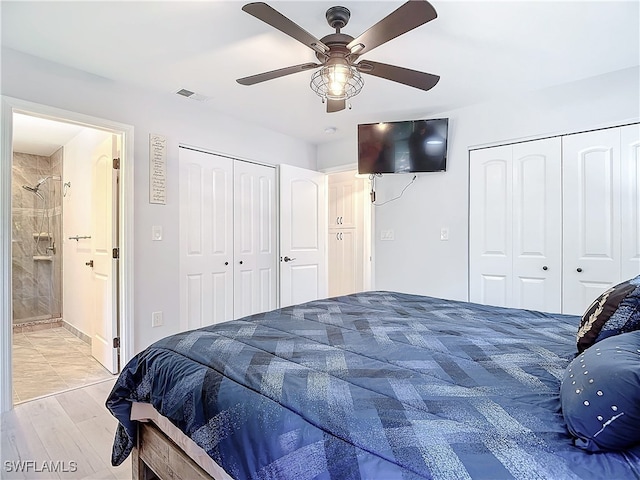 bedroom featuring ensuite bath, ceiling fan, and visible vents