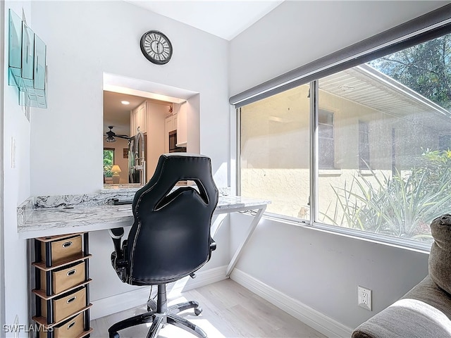 office area with light wood-type flooring and baseboards